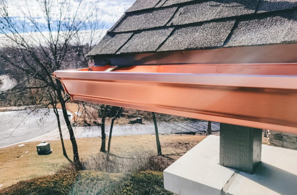 Seamless copper gutter professionally installed on a residential roof in New Jersey or Pennsylvania, highlighting expert craftsmanship and durable materials.